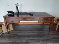 Front view of the desk showing drawers, legs and overall form