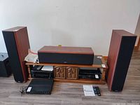 Front view of floorstanding speakers, center speaker and AV components