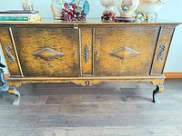 front view showing full sideboard with decorative veneer and hardware
