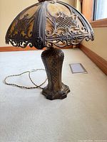 Full view of lamp showing base, slag glass shade and cord