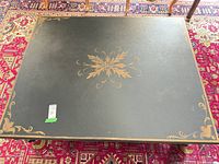 top view showing painted surface and gold motifs