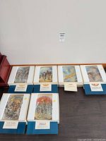 Seven boxed Yiannis Koutsis collector plates on floor