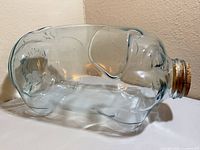 Left side view of aqua glass pig jar showing overall shape and clarity