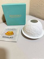 Full lot showing porcelain votive, booklet and box