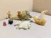 All six stone animal figurines grouped on surface
