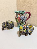 Pitcher and two elephant figurines