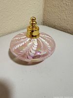 Front angled view showing bottle body, cap, and iridescent finish