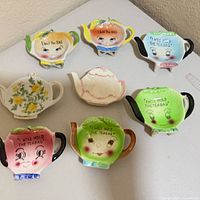 Group shot of all eight porcelain tea bag holders