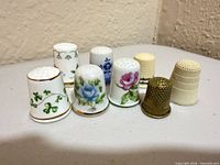 Group shot of all eight thimbles