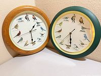 Both wall clocks side by side displaying dials and frames