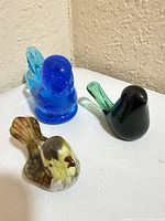 Three glass bird figurines grouped together