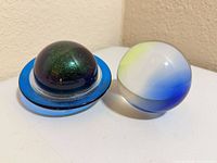 Both glass paperweights side by side