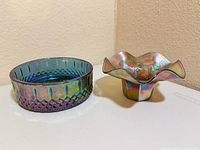 Both iridescent glass dishes side by side
