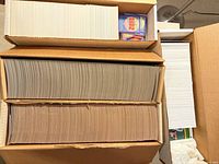 Open box showing two long rows of cards and additional stacks