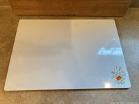 Top view of white enamel counter saver with floral decal