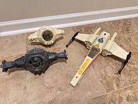 Overall view of three Star Wars vehicles on floor