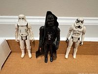 Front view of three vintage Kenner Star Wars figures—Snowtrooper, Darth Vader, Stormtrooper