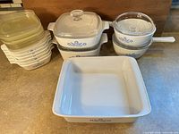Full set showing petite pans with lids, casseroles, saucepans, and baker