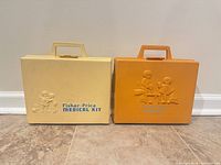 Front view of both Fisher-Price cases, yellow Medical Kit and orange Tool Kit