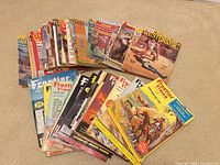Stack of Western magazines spread on carpet