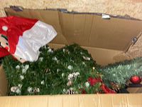Tree, ornaments and skirt visible inside box