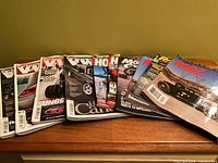 Wide shot of entire stack of approx. 15 automotive and motorcycle magazines