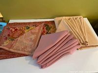 Group view of pink napkins, beige napkins, floral runner
