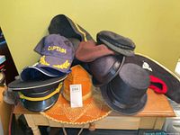 Overall view of stacked hats showing variety and quantity