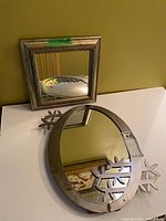 Square and round mirrors on table