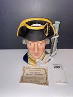 Front view of Admiral Lord Hood Toby jug with certificate card and lot tag