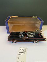 Batmobile diecast car in front of original box