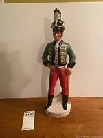 Full view of ceramic soldier decanter on base marked Irish Mist