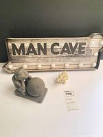 Overview showing MAN CAVE sign, tiki statue, elephant