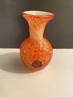 Full view of orange and white art glass vase