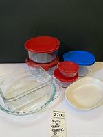 Group shot showing all glass bakeware, storage bowls with lids, and CorningWare dish