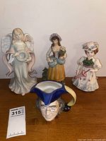 All four porcelain items in the lot displayed together