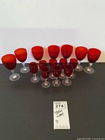 Full set of red and clear stemware, two sizes displayed