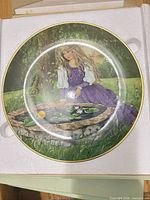 Front view of porcelain plate showing Frog Prince artwork and gold rim