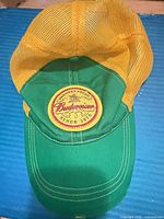 Top view showing green front, yellow mesh back, Budweiser logo patch