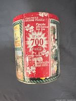Front of cylindrical Coca-Cola tin showing 700-piece label
