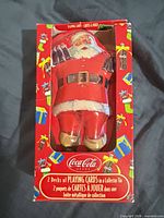 Front of outer box showing Santa-shaped tin inside