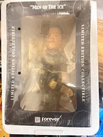 Front of shrink-wrapped box showing figure through window and Men of the Ice branding