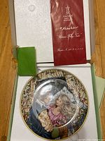 Plate inside presentation box with booklet visible