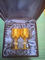 Pair of gold-plated goblets in blue satin-lined presentation box