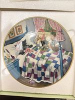 Front view of plate showing full illustration and gold rim in styrofoam holder