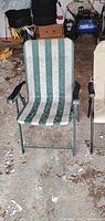 Green striped metal folding chair front view