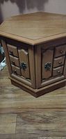 Hexagonal wood veneer end table front view showing door and faux drawers