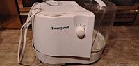 Exterior view of Honeywell cool mist humidifier showing brand logo, control dial, clear water tank and power cord