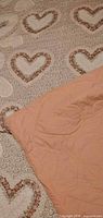 Floral heart quilt comforter showing peach reverse side
