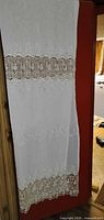 Full length view of one crochet curtain panel showing overall design and size